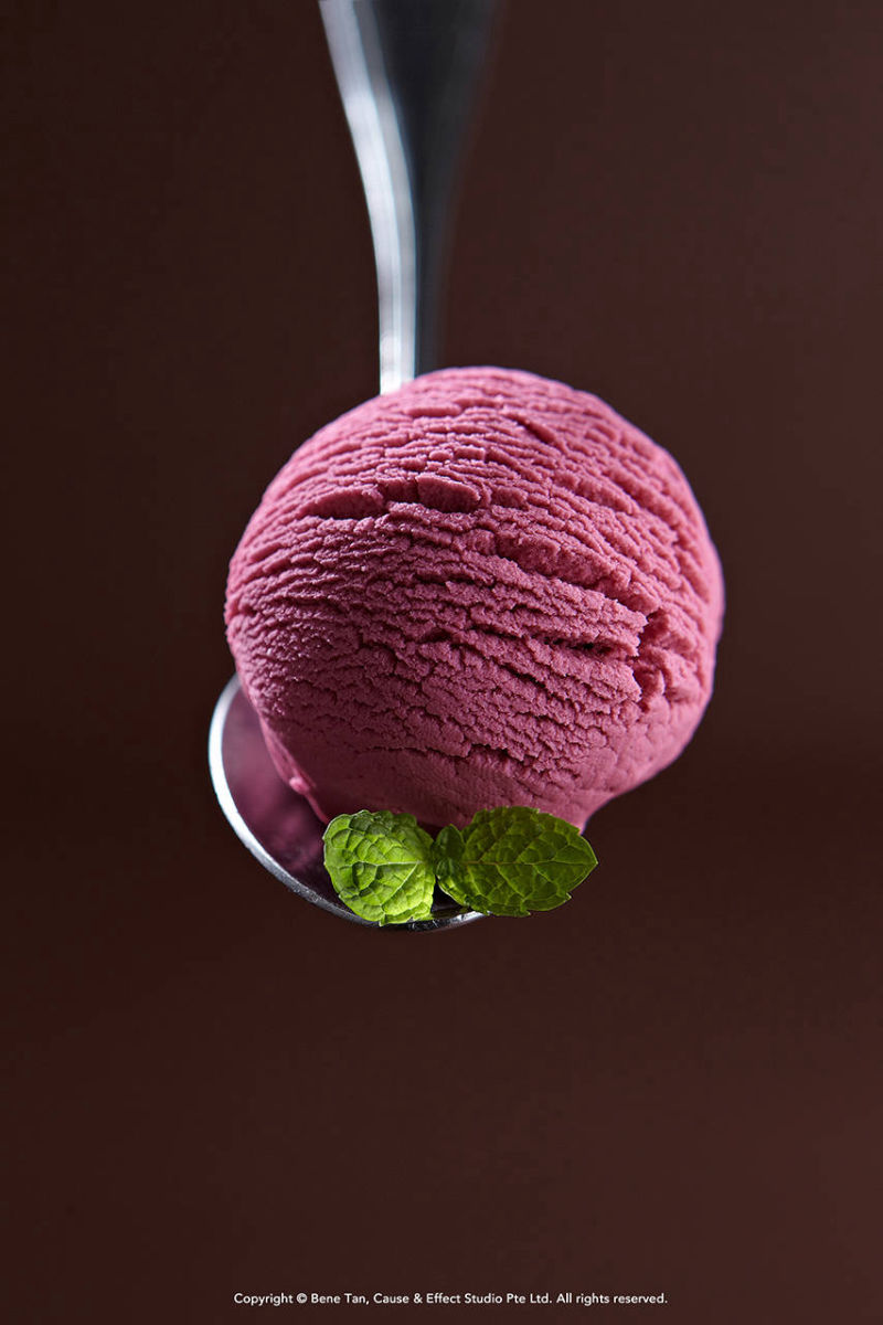 a scoop of strawberry ice cream with mint leave