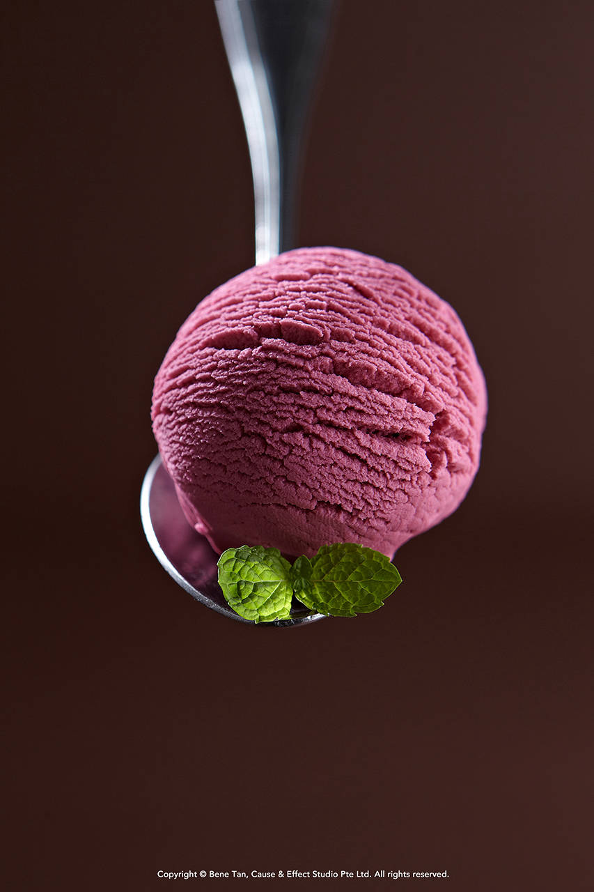 a scoop of strawberry ice cream with mint leave